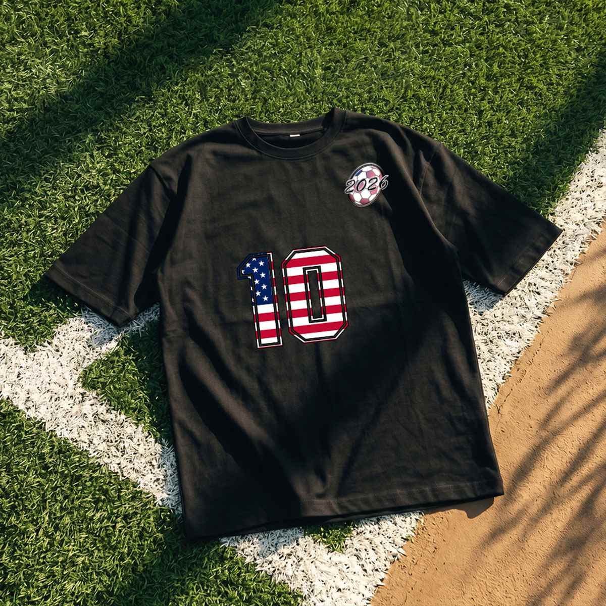 Black t-shirt with number 10 and American flag design on grass