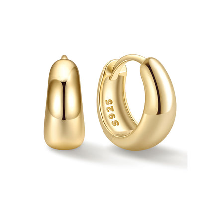8mm gold huggie earrings on a white background