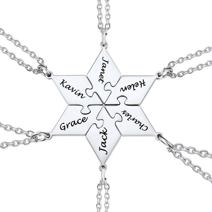silver puzzle necklace with interlocking puzzle pieces engraved with names on a white background